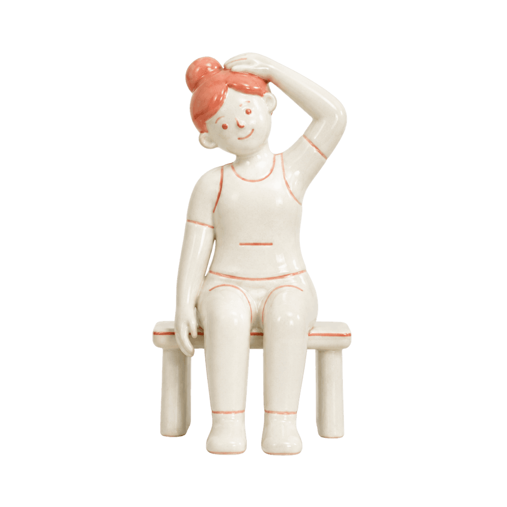 Ceramic figure seated on a bench, tilting its head into a neck side stretch.