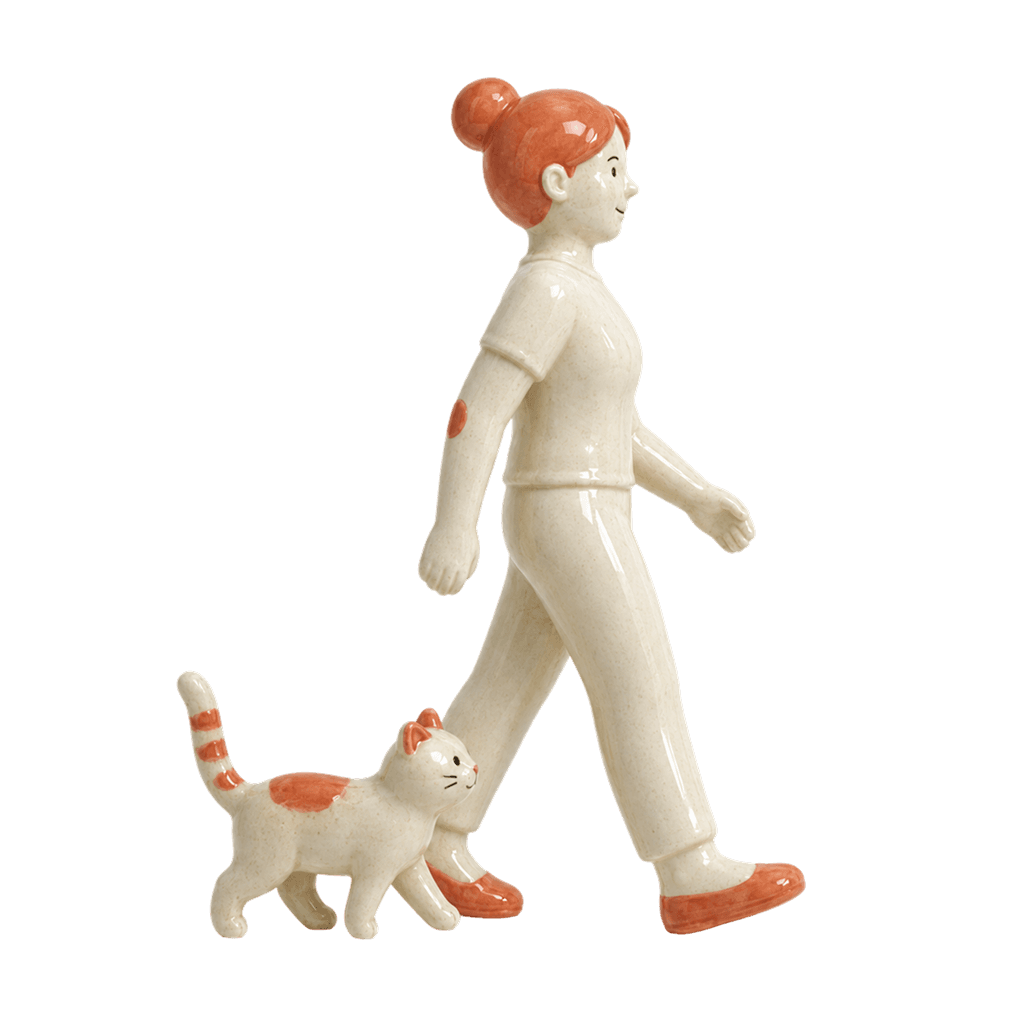 Ceramic figure walking a small cat.